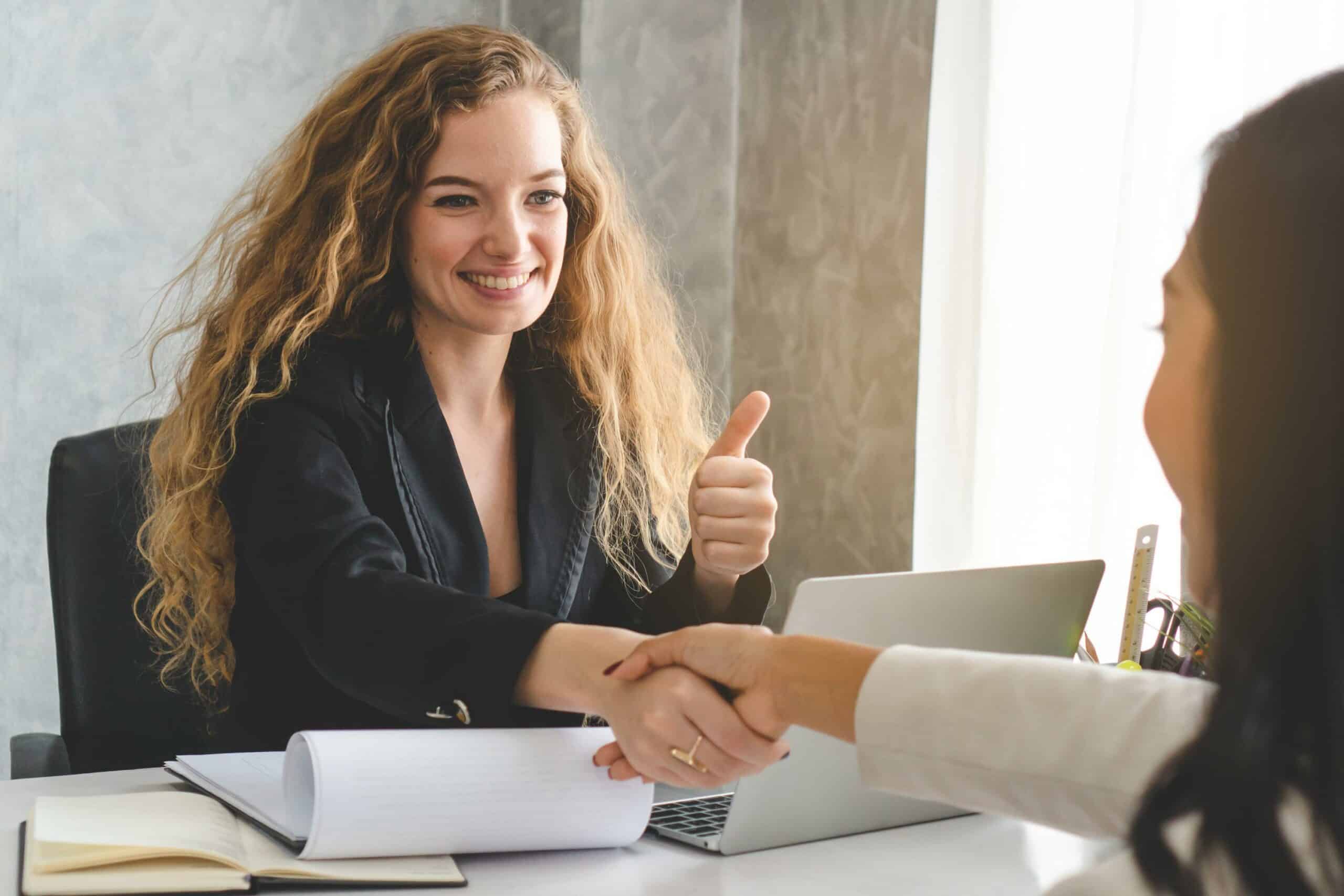Two businesswomen shaking hands