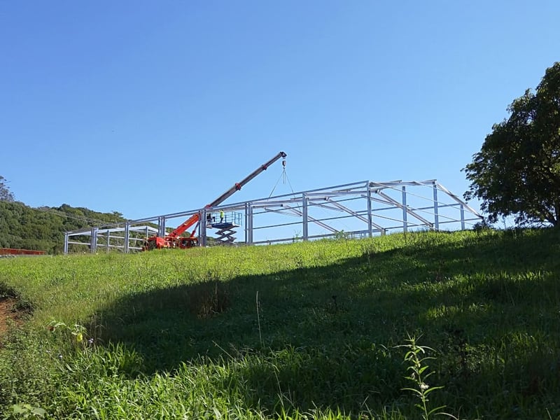 Mellish Crane lifting a metal shed construction into place